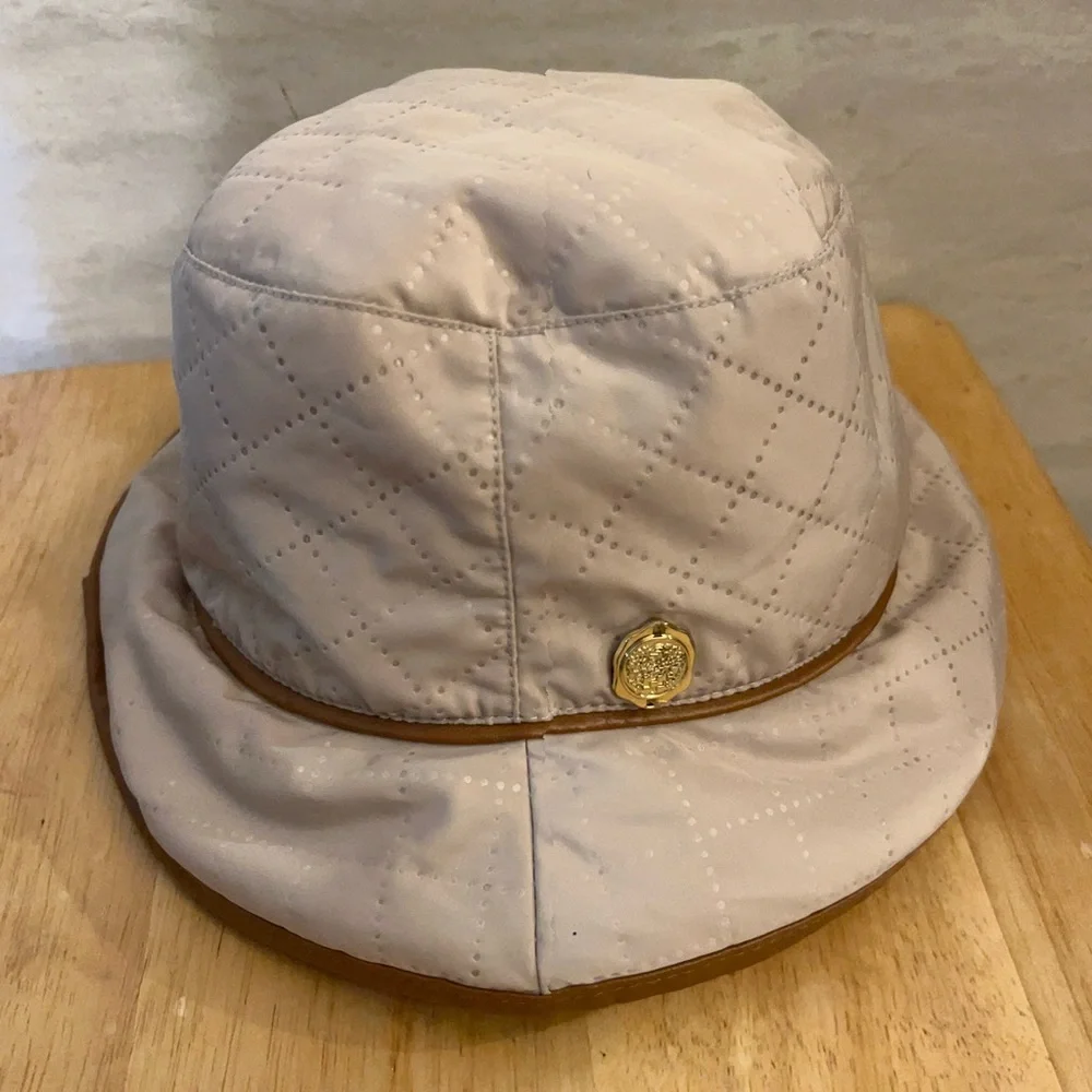 Vince Camuto Quilted Cream Bucket Hat with Tan Trim and Gold Emblem